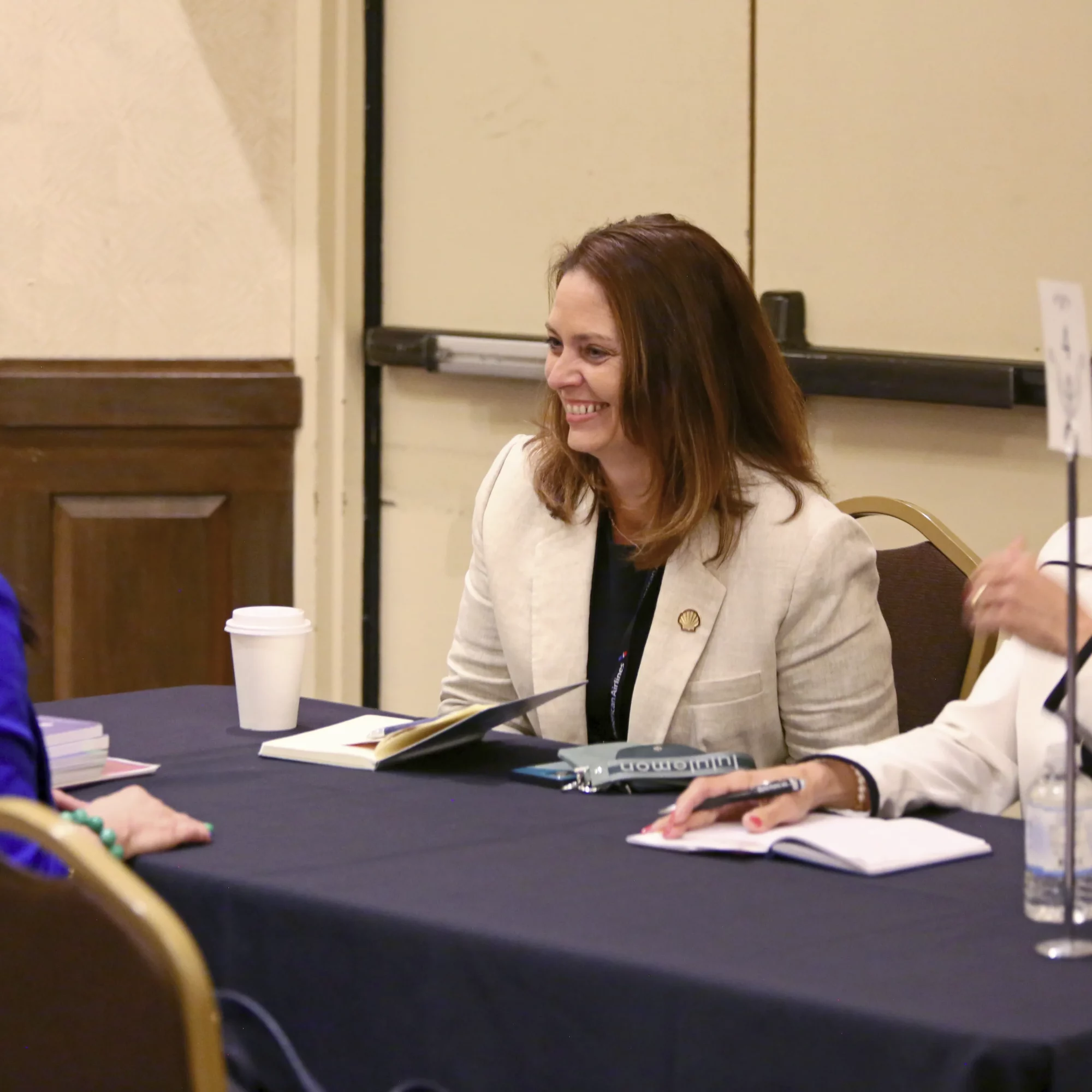 USHCC Energy Conference Attendees Smiling and Talking at Table